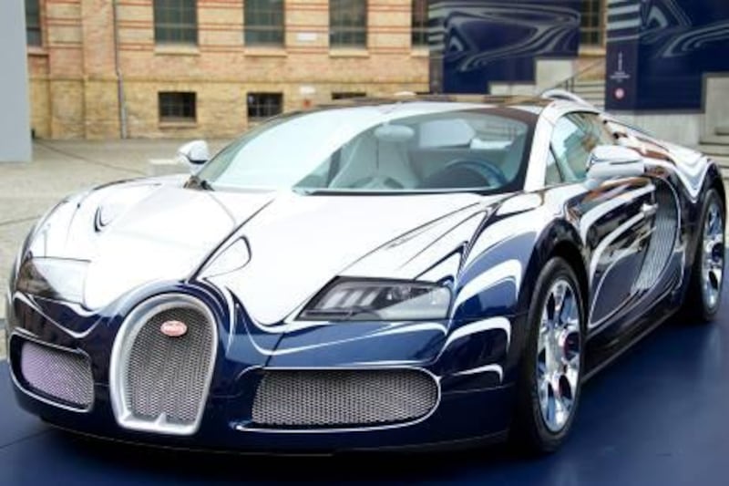 View of a newly-unveiled Bugatti Veyron 16,4 Grand Sport "L'Or Blanc" in Berlin on June 30, 2011. The luxury sports car, designed in cooperation with KPM - Königliche Porzellan-Manufaktur Berlin (Royal Porcelain Manufacture Berlin) features designs inspired from porcelain, and porcelain elements, costs EUR 1.600.000.    AFP PHOTO / JOHN MACDOUGALL
 *** Local Caption ***  325739-01-08.jpg