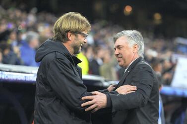 MADRID, SPAIN - APRIL 02: Juergen Klopp (L), coach of Borussia Dortmund is greeted by Carlo Ancelotti, coach of Real Madrid during the UEFA Champions League Quarter Final first leg match between Real Madrid and Borussia Dortmund at Estadio Santiago Bernabeu on April 2, 2014 in Madrid, Spain. (Photo by Dennis Grombkowski/Bongarts/Getty Images)