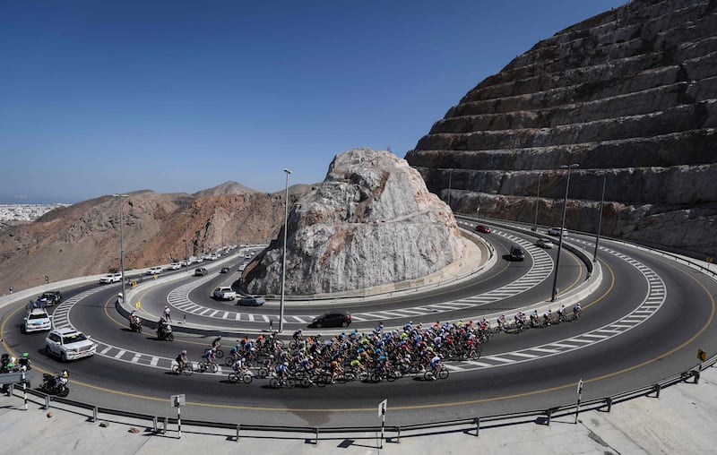 The peloton rides during the third stage of the 2022 cycling Tour of Oman between Sultan Qaboos University and Qurayyat. AFP