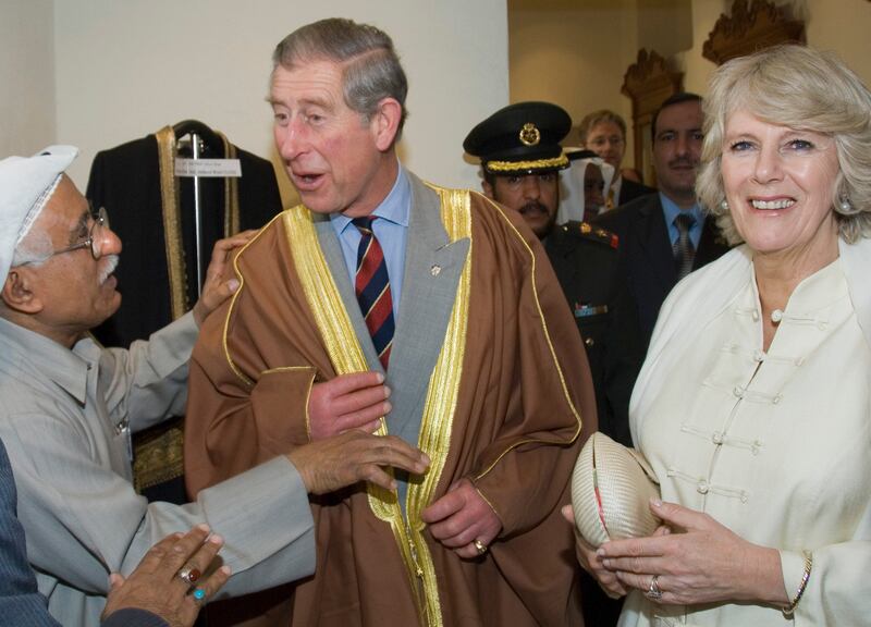 Prince Charles wears a bisht during a 2007 visit to a traditional handicraft centre in Kuwait with Camilla, now Queen Consort. Reuters 