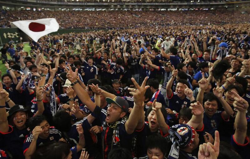 Japan's supporters react after Japan's first goal by Keisuke Honda as they watch the team's 2014 World Cup Group C match against Ivory Coast at a public viewing at the Tokyo Dome on Sunday. Yuya Shino / Reuters