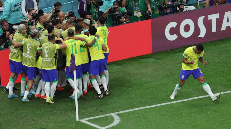 Richarlison in the middle of the celebrations after firing Brazil into a 1-0 lead. AFP