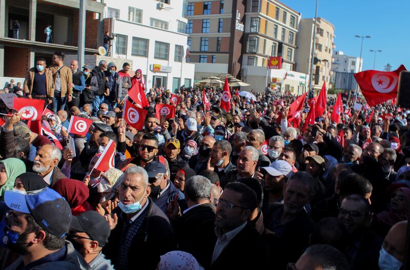 The streets of Tunis are filled with people and flags. AP