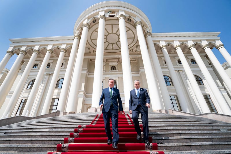 UK Foreign Secretary David Cameron, left, and his Tajik counterpart Sirojiddin Muhriddin leave the Palace of Nation in Dushanbe, Tajikistan, as part of a five-day tour of Central Asia. AFP