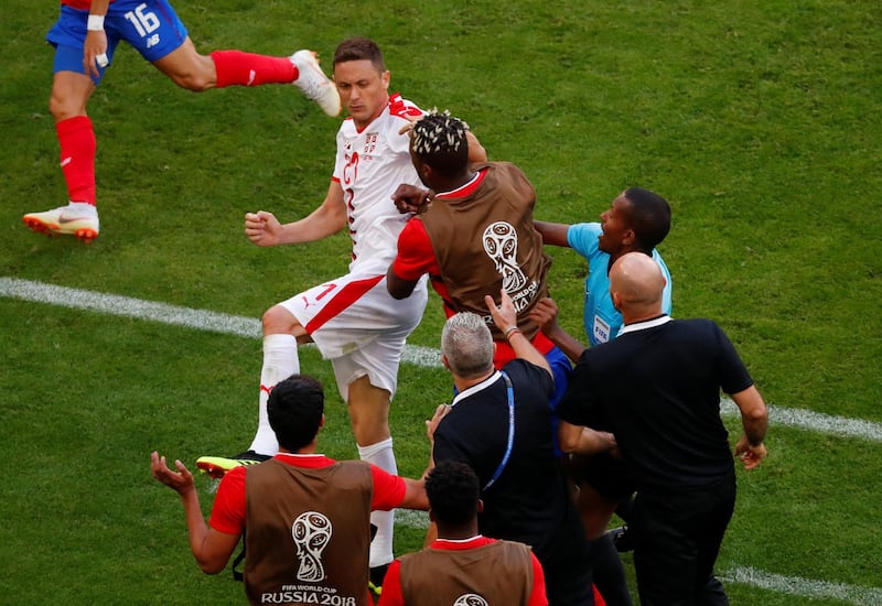 The referee separates Serbia's Nemanja Matic and Costa Rica's players and staff. David Gray / Reuters