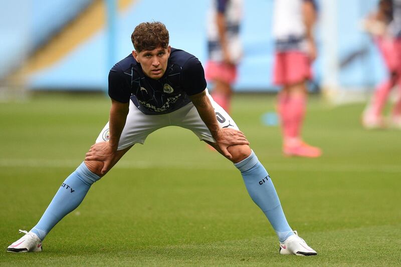 Manchester City's English defender John Stones warms up for the UEFA Champions League round of 16 second leg football match between Manchester City and Real Madrid at the Etihad Stadium in Manchester, north west England on August 7, 2020. / AFP / POOL / Oli SCARFF                          
