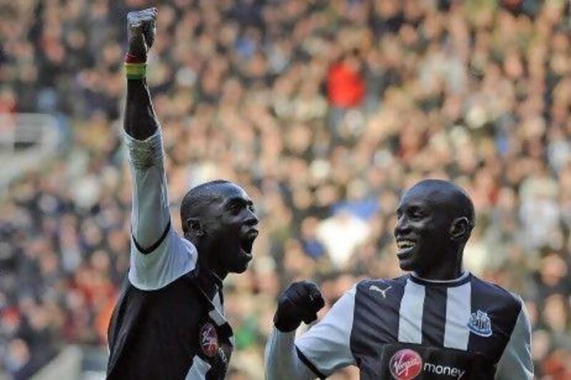 Newcastle United's Papiss Cisse, left, celebrates scoring with Demba Ba against Aston Villa during their English Premier League in Newcastle.