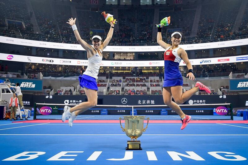 Yung-Jan Chan and Martina Hingis jump around the winner's trophy after winning the Women's Doubles Final against Timea Babos and Andrea Hlavackova at the 2017 China Open in Beijing.  Photo by Etienne Oliveau / Getty Images