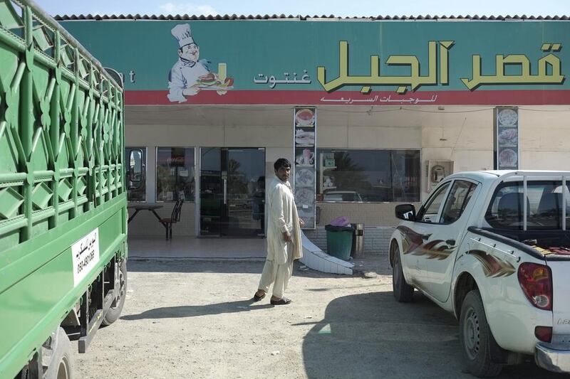 A Pakistani man stops to rest at the roadside cafe between the Ghantoot and Truck Road intersections on E11 Dubai-bound highway. Antonie Robertson/The National