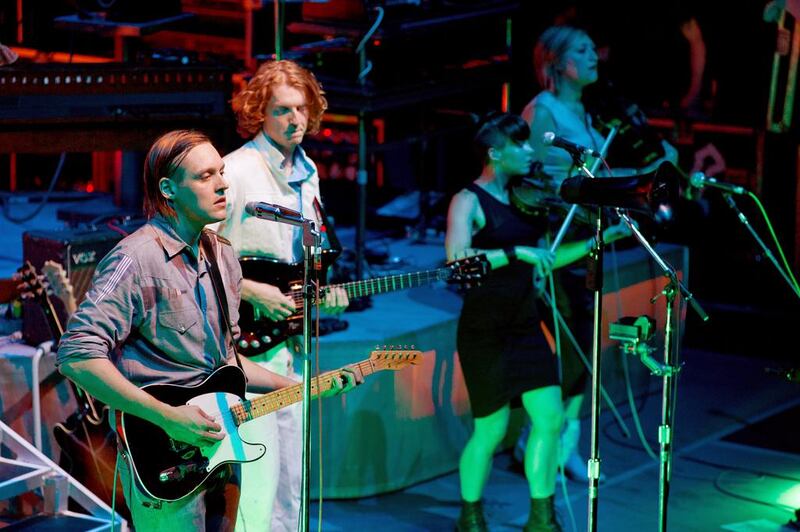 The musicians Win Butler, Richard Parry and Sarah Neufeld of Arcade Fire perform. Photo by Barney Britton / Redferns

