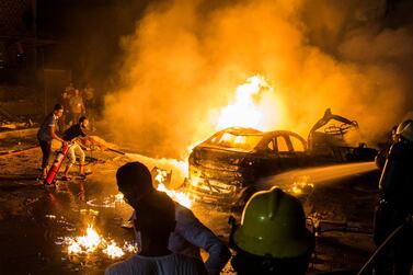 People attempt to extinguish a fire from a blast outside the National Cancer Institute, Cairo, Egypt. EPA