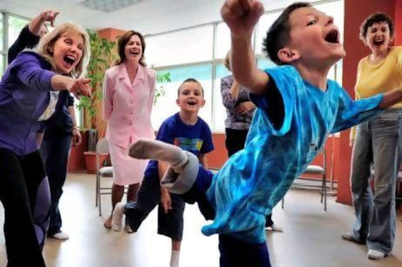 Jarod Hackenberg, seven, flies past Nira Berry, left, during a laughter yoga session. Linda Davidson / The Washington Post via Getty Images