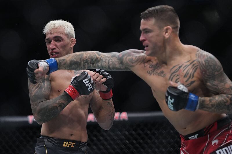 Dustin Poirier moves in with a hit against Charles Oliveira. Reuters