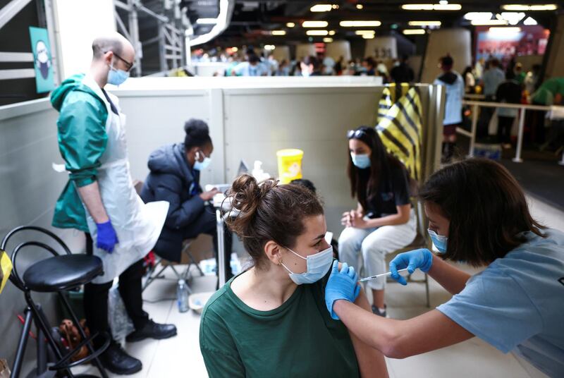 A person receives a dose of the Pfizer/BioNTech vaccine at a mass vaccination centre at the London Stadium. Reuters