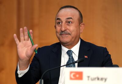 Turkey's Foreign Minister Mevlut Cavusoglu waves during the 'Second Berlin Conference on Libya' at the foreign office in Berlin, Germany, Wednesday, June 23, 2021. (AP Photo/Michael Sohn, pool)