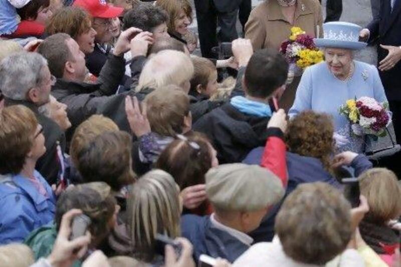 Britain's Queen Elizabeth II meets the public after a service in Enniskillen, Northern Ireland, in memory of 11 people who died in an 1987 IRA bombing.