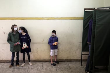 Children wait for their dad during the elections for governors, mayors, councillors and constitutional assembly members to draft a new constitution to replace Chile's charter, in Santiago, Chile May 15, 2021. REUTERS/Pablo Sanhueza