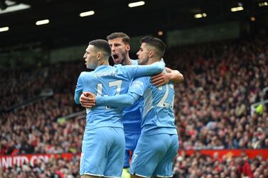 Phil Foden (L) and Joao Cancelo (R) of Manchester City celebrate following an own goal from Eric Bailly of Manchester United during the English Premier League soccer match between Manchester United and Manchester City in Manchester, Britain, 06 November 2021.   EPA/PETER POWELL EDITORIAL USE ONLY.  No use with unauthorized audio, video, data, fixture lists, club/league logos or 'live' services.  Online in-match use limited to 120 images, no video emulation.  No use in betting, games or single club / league / player publications