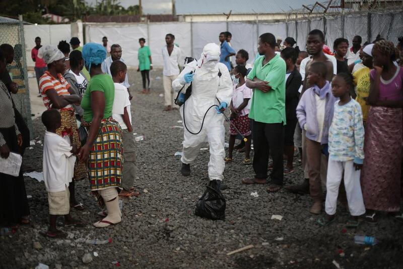 A medical worker sprays patients being discharged from the Island Clinic where the facility is preparing to release more than 50 survivors.