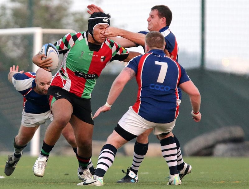 Abu Dhabi Harlequins, in red and green, facing Jebel Ali Dragons in the Gulf Top Six at the Jebel Ali Centre of Excellence on February 21, 2014. Jaime Puebla / The National