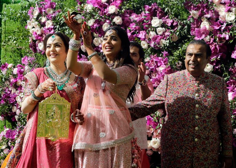 Reliance Industries Chairman Mukesh Ambani, right, his wife Nita Ambani, left, and daughter Isha arrive for son Akash Ambani's wedding in Mumbai. Photo: AP