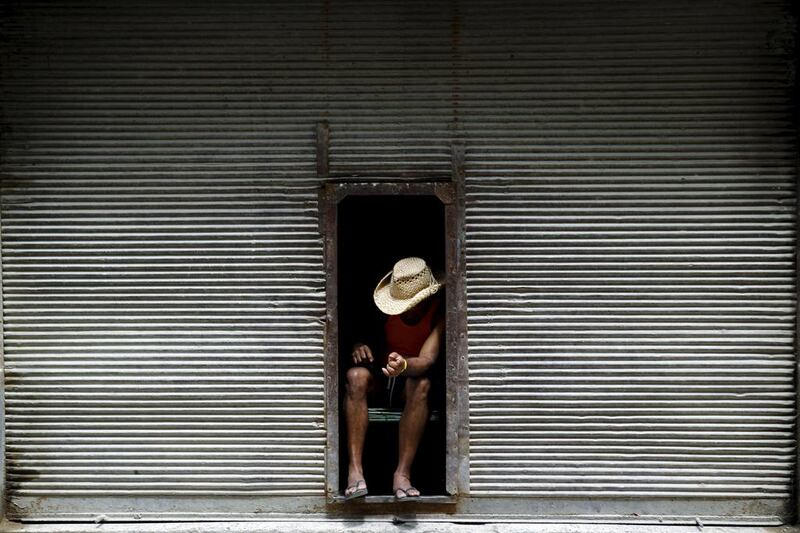 A man takes a break at a door of a closed store in Havana. Ivan Alvarado / Reuters