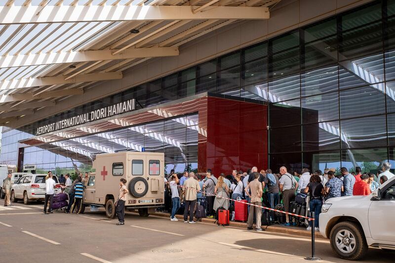 Passengers queue outside Diori Hamani International Airport in Niamey on August 2, as part of an evacuation by France. AFP