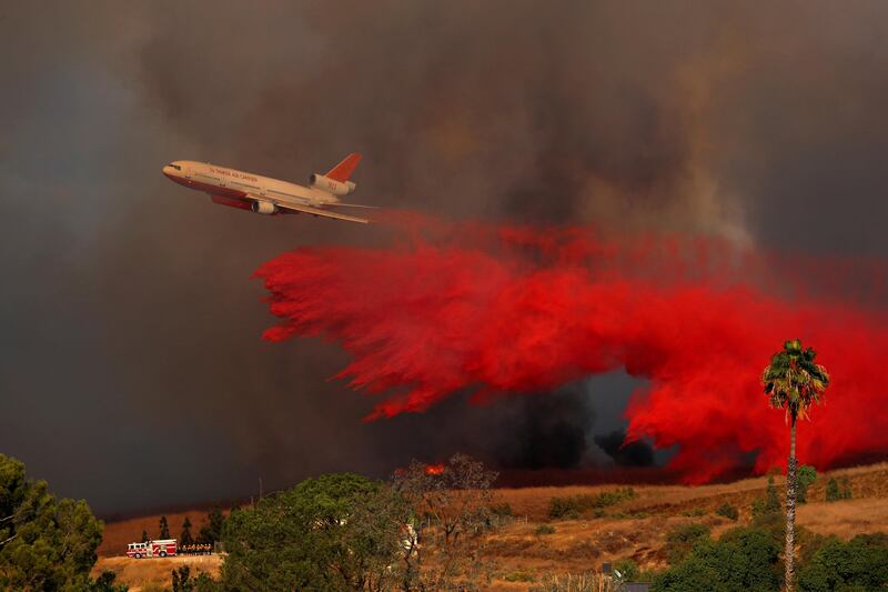 A DC-10 aircraft drops fire retardant in Orange, California. Mike Blake / Reuters