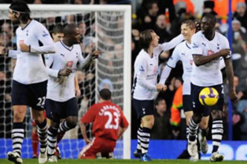 Tottenham players celebrate after Liverpool's Jamie Carragher's own goal levelled the scores at White Hart Lane before Spurs went on to win 2-1.