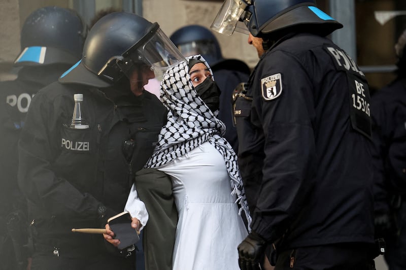Police officers remove a pro-Palestinian activist as protesters occupy a building at Humboldt University in Berlin. Reuters