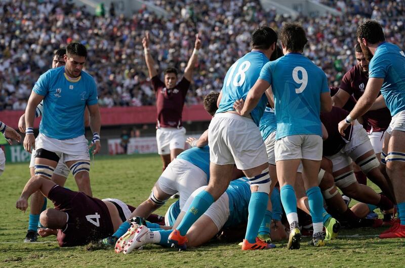 Jaba Bregvadze, hidden in pack, scores a try for Georgia against Uruguay.  EPA