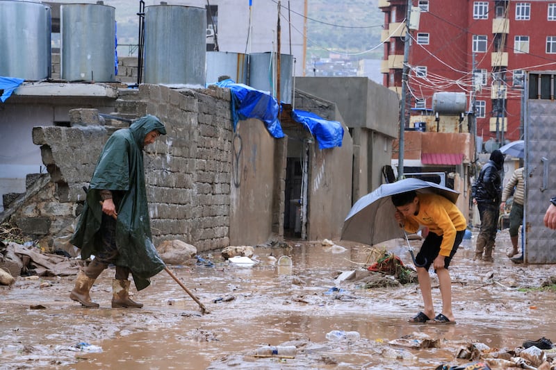 People clean up after floods in Duhok, Iraq, on March 19. Reuters