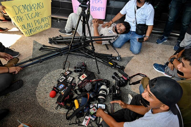 Journalists lay down their equipment as they protest against the latest draft revision of the broadcasting law in Indonesia. AFP