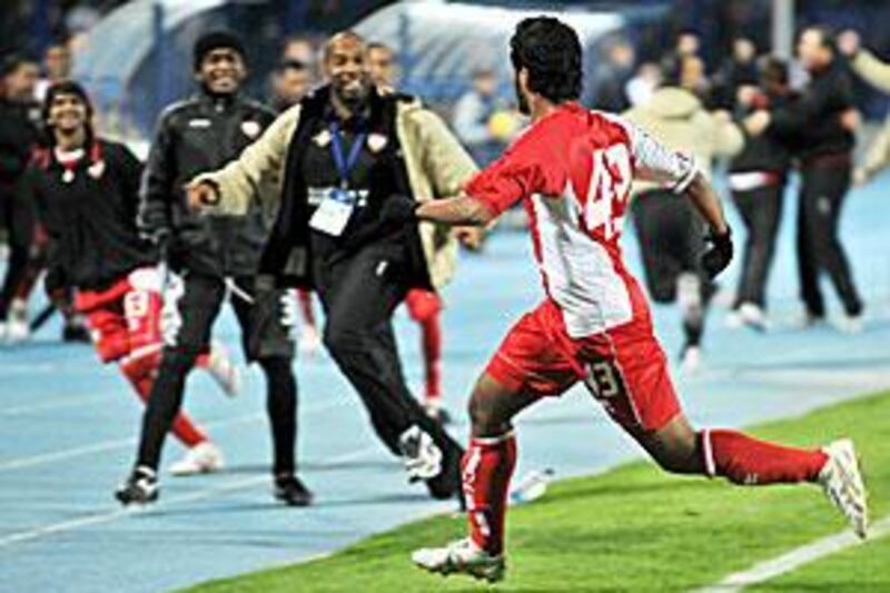 Sultan al Menhali runs to greet his teammates on the sidelines after scoring the UAE's winner against Uzbekistan.