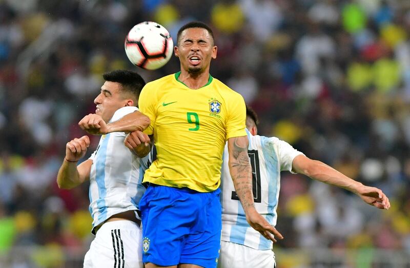 Brazil forward Gabriel Jesus tussles with Argentina's Rodrigo Battaglia and Nicolas Tagliafico. Reuters