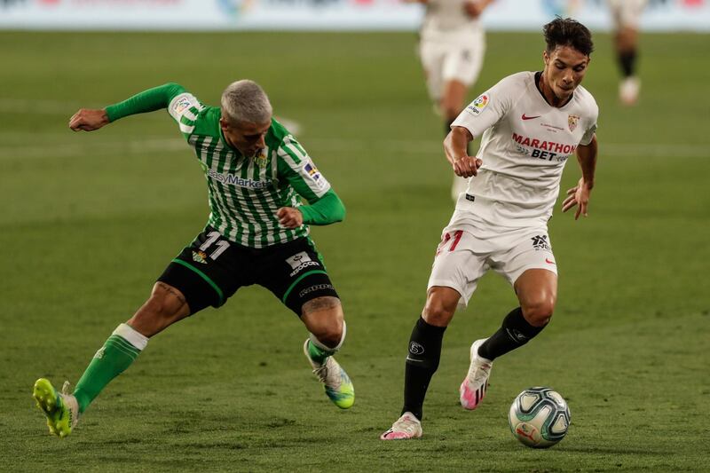 Sevilla's Oliver Torres shields the ball from Cristian Tello of Real Betis. AP