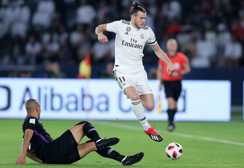 Abu Dhabi, United Arab Emirates - December 22, 2018: Gareth Bale of Real Madrid competes with Ismail Ahmed of Al Ain during the match between Real Madrid and Al Ain at the Fifa Club World Cup final. Saturday the 22nd of December 2018 at the Zayed Sports City Stadium, Abu Dhabi. Chris Whiteoak / The National