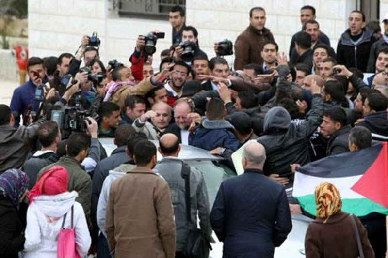 Palestinian university students surround the British consul general Sir Vincent Feanat Bir Zeit University on Tuesday. Abbas Momani / AFP