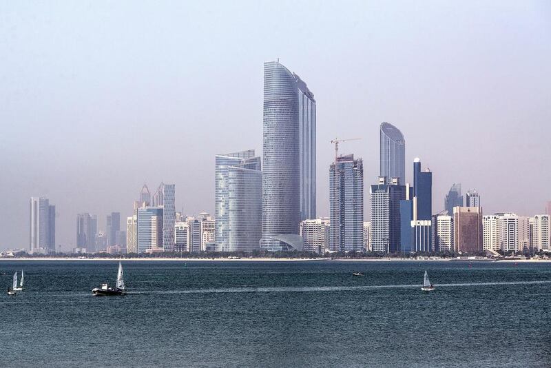 The Landmark skyscraper, center, stands on the city skyline beside a waterway in Abu Dhabi. Alex Atack / Bloomberg