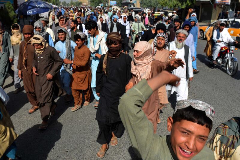 Local residents take part in a protest march against a reported announcement by the Taliban, asking them to evict their homes built on state-owned land in Kandahar. AFP