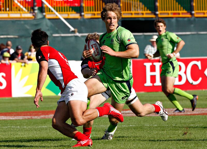 Dubai , United Arab Emirates, Dec 2 2011, Aus v Canada ,  (centre) Australia's #10 Lewis Holland powers himself through Candian defenders during action at the Emirates airlenes Dubai Rugby Sevens. Mike Young / The National
