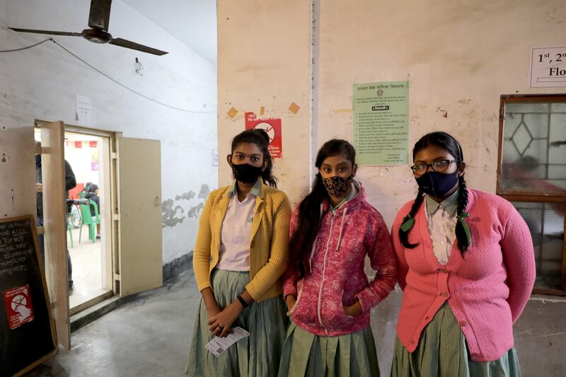 Pupils visit their school in Kolkata to be inoculated against Covid-19. EPA