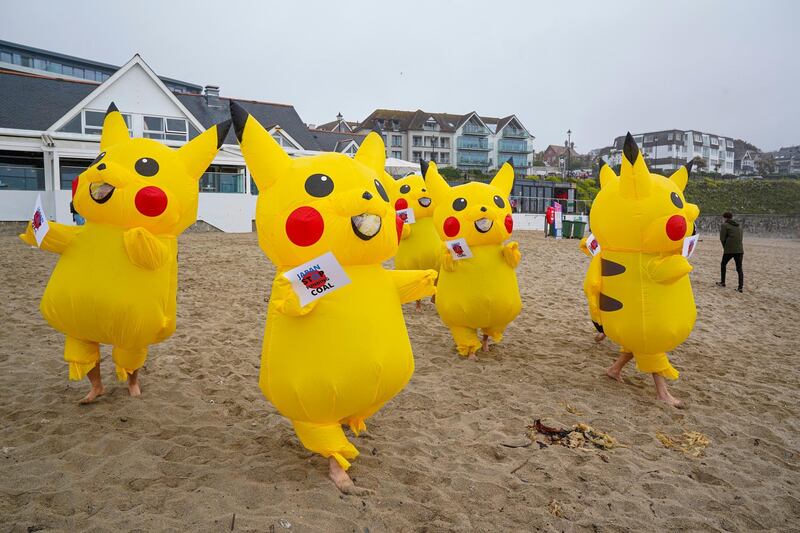 Protesters dressed as Pikachu characters demonstrate on Gyllyngvase Beach, calling on the Japanese government to stop burning coal by 2030, in Falmouth. Getty Images