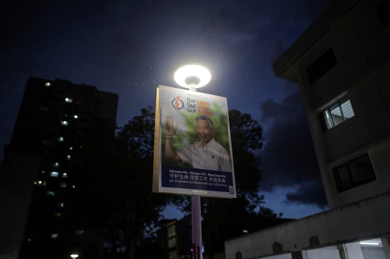 epa08520940 A campaign poster showing Singapore Prime Minister Lee Hsien Loong of the incumbent People's Action Party on a lamp post ahead of the general election in Singapore,  01 July 2020. Singaporeans will go to the polls amidst the coronavirus disease (COVID-19) pandemic to vote in the 18th parliamentary general elections  where 93 seats will be contested.  EPA/WALLACE WOON