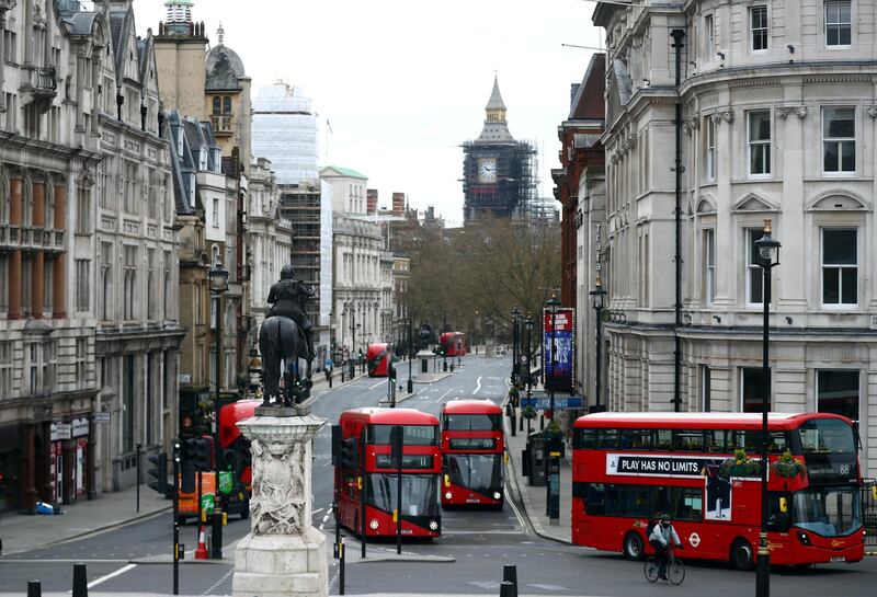 London buses travel along Whitehall in Westminster in London, Britain, April 2, 2021. REUTERS/Hannah McKay