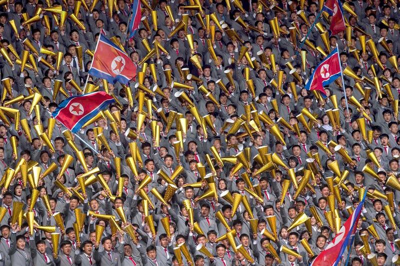 North Korea fans cheer on their team during the AFC Women’s 2018 Asian Cup Group B qualifying football match against South Korea at the Kim Il-Sung stadium in Pyongyang. The South's flag flew and its anthem played as its women’s team played to a 1-1 draw with its neighbours, in the first competitive football match between the two countries hosted by the North. Kim Won-Jin / AFP / April 7, 2017