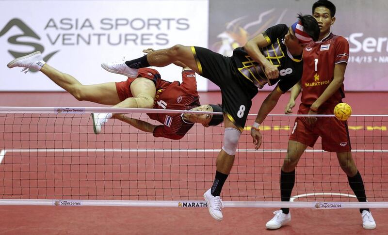 Thailand’s Anuwat Chaichana (L) and Malaysia’s Khairol Zaman in action during their mens final match. Asia Sports Ventures / Action Images via Reuters