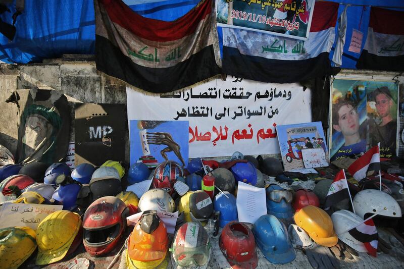 A shrine to honour the demonstrators who were killed during protests, made of their helmets and portraits, at Tahrir square in central Baghdad.   AFP