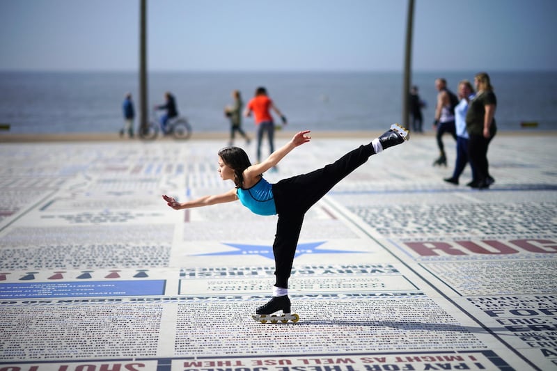 A girl practises her skating skills in the spring sunshine on the promenade at Blackpool, in north-west England. Getty Images