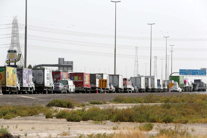 DUBAI, UNITED ARAB EMIRATES , June 2 – 2020 :- Traffic jam at the Dubai border going towards Abu Dhabi on Sheikh Zayed road in Dubai. Abu Dhabi Police checking the movement permits at the police checkpoint on the Dubai – Abu Dhabi border on Sheikh Zayed road in Dubai. Abu Dhabi impose one week ban starting from Tuesday on travel on entering and leaving the emirate to reduce the spread of Covid-19  and ensure its huge testing drive works. (Pawan Singh / The National) For News/Online 